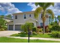 Attractive home with a three-car garage and mature palm trees at 2463 Carnation Ct, North Port, FL 34289