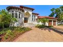 Stately home showcasing a grand staircase leading to double doors and a circular turret-style window feature at 2613 N Dundee St, Tampa, FL 33629