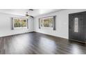 Bright living room showcasing hardwood floors, fresh white walls, and windows that let in natural light at 2719 Boca Ciega N Dr, St Petersburg, FL 33710