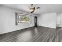 Spacious living area featuring hardwood floors, a modern ceiling fan, and a bright window view at 2719 Boca Ciega N Dr, St Petersburg, FL 33710