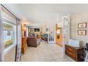 Comfortable living room with tile flooring, leather furniture, and a view into the kitchen at 27466 Us Highway 19 N # 56, Clearwater, FL 33761