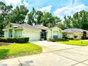 Charming single-story home showcasing lush landscaping, a two-car garage, and a welcoming tiled roof at 2776 Golf Lake Dr # 1, Plant City, FL 33566