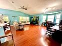Spacious living room with wood floors, vaulted ceilings, and bright natural light from large windows at 2776 Golf Lake Dr # 1, Plant City, FL 33566