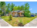 Charming home with lush greenery, featuring a well-maintained lawn and inviting atmosphere at 3100 11Th N Ave, St Petersburg, FL 33713
