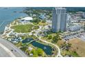 Expansive aerial view showcasing the high-rise location adjacent to a park with water features and winding paths at 331 Cleveland St # 1202, Clearwater, FL 33755
