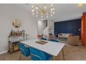 Chic dining space featuring a sleek table, statement lighting, and an open-concept design at 4639 Bexley Village Dr, Land O Lakes, FL 34638