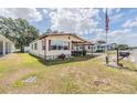 Cozy single-story home with a carport and green grass at 5524 Betmar Dr, Zephyrhills, FL 33542