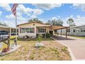 Charming single-story home with a carport and manicured lawn at 5524 Betmar Dr, Zephyrhills, FL 33542