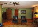 Comfortable living room with hardwood floors, muted green walls, and traditional decor at 5602 N Dormany Rd, Plant City, FL 33565