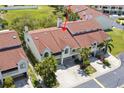 Aerial view of a townhome featuring a brown roof and mature trees at 621 Duchess Blvd, Dunedin, FL 34698