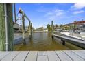Dock with boat lift and views of nearby luxury waterfront homes at 621 Duchess Blvd, Dunedin, FL 34698