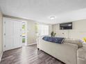 Bright and open living room with wood-look floors and natural light streaming through the windows at 6627 Main St, New Port Richey, FL 34653
