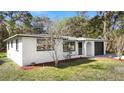 Well-maintained home featuring a freshly painted exterior, manicured landscaping, and an attached one-car garage at 7926 Gulf Way, Hudson, FL 34667