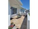 Cozy outdoor patio with tiled flooring, seating, and a small wall for added privacy at 9035 37Th N St, Pinellas Park, FL 33782