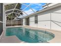 A tranquil pool area, enhanced by a screened enclosure and direct access to the home through sliding glass doors at 9818 White Barn Way, Riverview, FL 33569