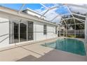 Enjoy this in-ground pool with a screened-in enclosure and views of the home's sliding glass doors for easy access at 9818 White Barn Way, Riverview, FL 33569