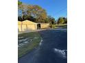 Attached two-car garage with a rustic wooden storage shed at 9900 Ideal Ln, Hudson, FL 34667