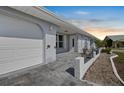 Inviting home exterior showcasing a covered entrance, a garage, and decorative architectural details at 1002 Strawpocket Pl, Sun City Center, FL 33573