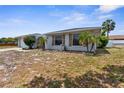 Low-angle exterior showcases the home's architectural details and mature landscaping at 10119 Briar Cir, Hudson, FL 34667