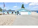 Inviting single-story home featuring a well-maintained driveway and a meticulously landscaped front yard at 1015 Spindle Palm Way, Apollo Beach, FL 33572