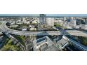 Expansive aerial view of a modern city with a high-rise building surrounded by highways, urban landscape, and waterfront at 1101 E Jackson St # 2519, Tampa, FL 33602