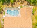 Aerial view of a home featuring a screened-in kidney-shaped pool and well-maintained roof at 11284 Hickory Ridge Ct, Spring Hill, FL 34609