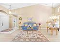 Bright living room with high ceilings, neutral walls, and attractive decor with light, wood-look floors at 11284 Hickory Ridge Ct, Spring Hill, FL 34609