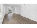 Spacious living room with modern flooring, ceiling fan, large sliding glass doors, and abundant natural light at 116 Hallam Ct, Spring Hill, FL 34606