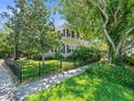 Charming home with a fenced yard, lush landscaping, and a well-manicured lawn at 125 29Th N St, St Petersburg, FL 33713