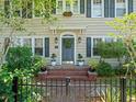 Inviting entrance with a decorative wreath, sconces, and lovely landscaping at 125 29Th N St, St Petersburg, FL 33713