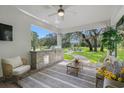 Spacious covered outdoor living area with barbecue, seating, and views of the lush backyard at 17466 Nokota Ave, Hudson, FL 34667