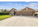 Charming one-story home featuring a well-manicured lawn, a two car garage and a concrete driveway at 2611 Eagle Crest Ct, Holiday, FL 34691