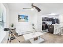 Bright living room flows into the kitchen with modern finishes and stainless steel appliances at 26377 Bertram Rd, Brooksville, FL 34602