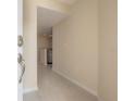 Bright entryway with neutral paint, light tile floor, and a view of the kitchen at 3073 Overlook Pl, Clearwater, FL 33760