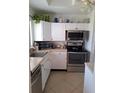 Efficient kitchen featuring stainless steel appliances and ample cabinet space at 361 Fairhaven St, Port Charlotte, FL 33952