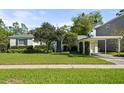 Landscaped front yard with a charming carport enhances this home's curb appeal and outdoor functionality at 3711 W Dale Ave, Tampa, FL 33609