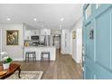 Modern kitchen features a breakfast bar, stainless steel appliances, and white cabinetry, ideal for cooking at 3711 W Dale Ave, Tampa, FL 33609