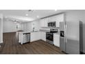 Stylish kitchen with stainless steel appliances, granite countertops, and ample cabinet space at 4348 Deltona Blvd, Spring Hill, FL 34606