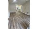 The living room showcases new wood grain vinyl flooring and fresh paint at 613 Coronet St, Plant City, FL 33563
