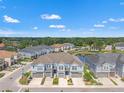 A stunning aerial view of the townhome community with a picturesque pond and lush greenery at 6731 Rocky Park St, Tampa, FL 33625