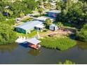 Waterfront property with private dock and boat lift, surrounded by lush greenery at 6904 11Th Ave E, Palmetto, FL 34221