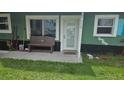 View of the front porch with a bench, door, and windows of the exterior of this home at 6904 11Th Ave E, Palmetto, FL 34221
