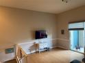 Bright living room featuring hardwood floors, a sliding glass door to a patio, and neutral paint at 716 Seagate Dr # 716, Tampa, FL 33602