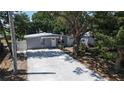 Attractive single-story home with a long driveway, a basketball hoop, and mature trees at 7428 36Th N Ave, St Petersburg, FL 33710