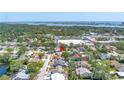 Aerial view of a residential neighborhood with mature trees, showcasing the home's location near the water at 8130 129Th N Ln, Seminole, FL 33776