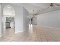 Spacious living room featuring tile flooring, neutral walls, vaulted ceiling, and chandelier lighting at 8408 Nuzum Rd, Brooksville, FL 34613