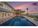 Luxury backyard with a sparkling pool, balcony, and waterfront view at 8488 35Th N Ave, St Petersburg, FL 33710