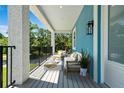 Inviting balcony with outdoor seating and view of mature trees; perfect for relaxing and enjoying the scenery at 1033 Hammock Cir, Tarpon Springs, FL 34688