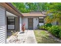 Close up of home's entrance showcasing the door, garden area, and covered parking to the left at 11536 Baywood Meadows Dr # 3, New Port Richey, FL 34654