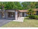 Charming single-story home featuring a covered parking area and lush front yard landscaping at 11536 Baywood Meadows Dr # 3, New Port Richey, FL 34654